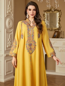Elegant yellow long-sleeved ethnic kaftan dress with colorful embroidery and V-neckline