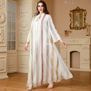 Elegant white chiffon kaftan with colorful sequin stripes in a classic interior setting