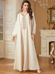 Exquisite gold and red embroidery and beadwork on a cream kaftan maxi dress