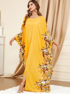 Détail de la robe jaune à manches chauve-souris avec imprimé fleuri et fente