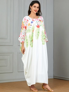 Elegant white kaftan maxi dress with colorful floral print and palm leaf patterns