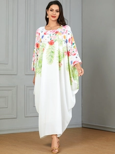 Elegant white kaftan dress with colorful floral print and loose holiday style fit
