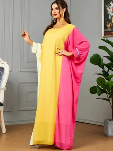 Detailed view of tricolor contrast kaftan dress featuring rhinestone cuffs and flowy fabric