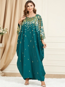 Detail of dark green batwing sleeve maxi dress featuring elegant gold foil floral print