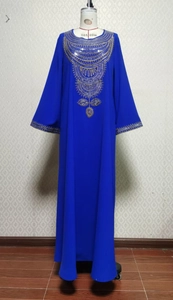 Détail de la broderie à paillettes dorées sur la robe longue ethnique bleu foncé
