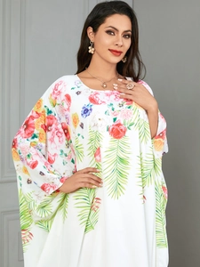 Close-up of lightweight floral maxi dress with red roses and blue flower prints
