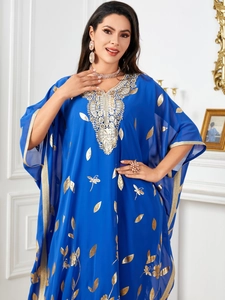 Detail of gold floral embroidery and leaf pattern on a navy blue chiffon kaftan dress