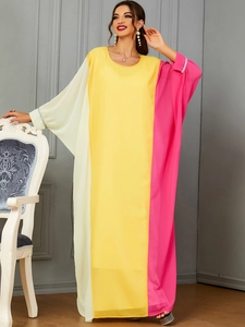 Detail of contrast color patchwork kaftan dress with rhinestone cuffs and loose fit