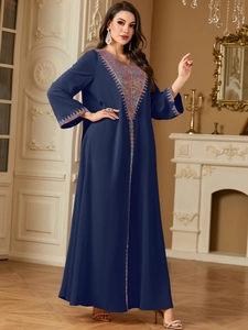 Detailed view of bohemian colorful geometric embroidery on navy blue Abaya dress neckline