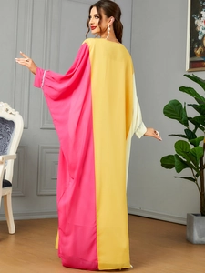 Detailed view of contrasting yellow and rose pink loose-fit gown with beaded cuffs