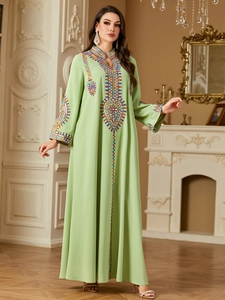 Exquisite embroidery detail on the neckline and sleeves of this green ethnic kaftan dress