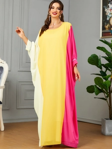 Detail of color-block kaftan dress featuring rhinestone embellishments on sleeve cuffs
