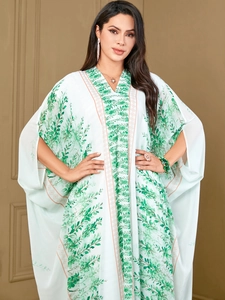 Plus size light green kaftan dress with botanical leaf print and wide batwing sleeves