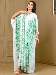 Detail of V-neck and tropical leaf print on plus size kaftan dress with batwing sleeves