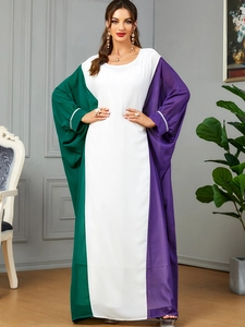 Detail of color-block kaftan dress featuring rhinestone embellishments on the cuffs