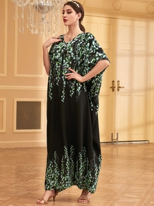 Ethnic kaftan maxi dress in black with green floral print and V-neck batwing sleeves