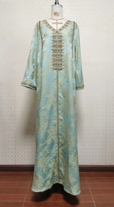 Detail of light blue Kaftan with gold floral jacquard and intricate beaded embroidery