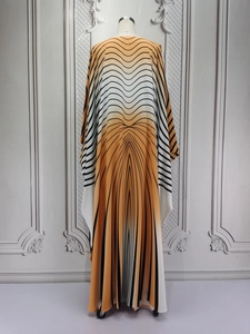 Detail showing elegant yellow and black striped kaftan dress with draped batwing sleeves