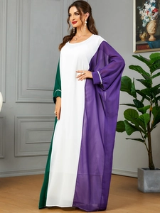 Detailed view of elegant color-block caftan with pearl accents on bishop sleeves