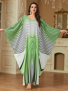 Close-up of elegant batwing sleeves and geometric wavy print on long kaftan dress