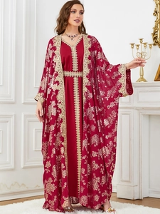 Detail of red kaftan with gold embroidery and floral patterns on high-quality fabric