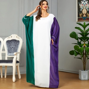 Three-color block abaya with batwing sleeves and rhinestone cuffs in an indoor setting