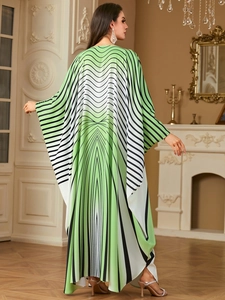 Rear view of long kaftan maxi dress featuring geometric green waves and batwing sleeves