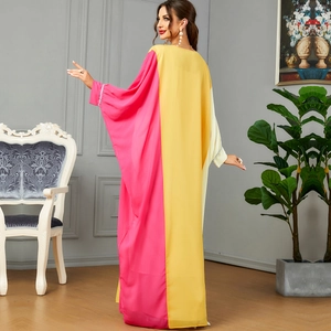 Elegant long sleeve maxi dress in vibrant pink and yellow color-block patchwork design