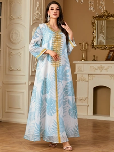 Bohemian white maxi dress with light blue tropical leaf print and gold embroidery