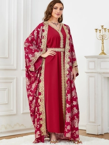 Close-up of elegant dark red Kaftan dress featuring intricate gold floral embroidery and matching belt