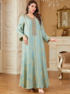 Detailed view of light blue Kaftan dress with gold floral jacquard and beaded embroidery
