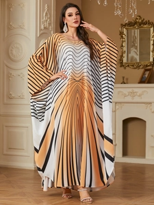 Detail of elegant geometric gradient print on long batwing sleeve kaftan dress