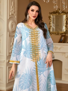 Elegant floral print maxi dress with gold embroidery and V-neckline on white fabric