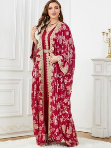 Detailed close-up of dark red kaftan set featuring gold lace and embroidery on sleeves
