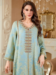 Detailed beadwork and floral patterns on a light blue evening kaftan dress with V-neck