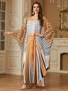 Close-up of elegant batwing sleeve dress with vibrant black and orange striped pattern
