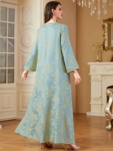 Close-up of light blue kaftan dress with gold floral jacquard and embroidered cuffs
