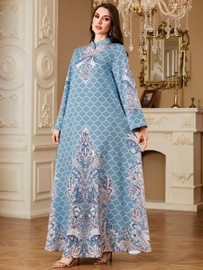 Detailed view of blue Abaya gown featuring intricate paisley prints and a high neckline