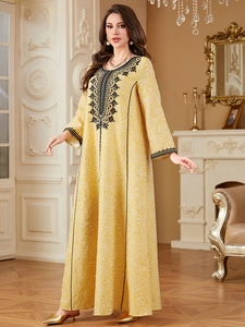 Elegant yellow jacquard kaftan dress with black embroidery and loose-fit silhouette