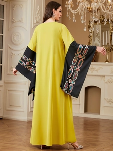 Detailed close-up of sequin embroidery on wide sleeves of lime green kaftan jalabiya dress