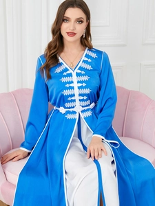Detail of embroidered royal blue kaftan set with white lace trim and tassel belt