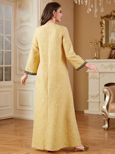 Elegant gold kaftan dress with floral jacquard and black lace cuffs for formal occasions