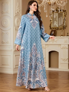 Detail of elegant blue maxi dress with paisley ethnic patterns and white grid prints