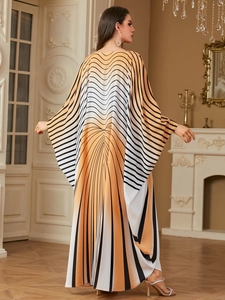 Detail shot of elegant geometric print kaftan dress with stylish batwing sleeves texture