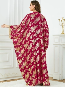 Detail of red kaftan with gold floral print and heavy embroidery on wide sleeve cuffs