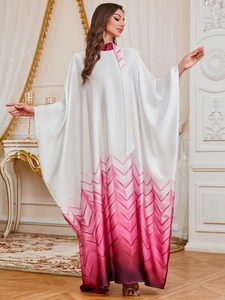 Detail view of smooth silk-like gradient kaftan dress with unique V-pattern hem textures
