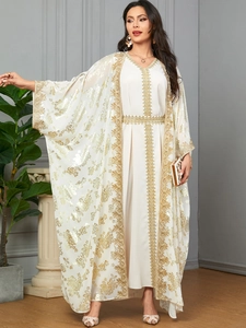 Detail of cream white kaftan set with exquisite gold embroidery and floral patterns