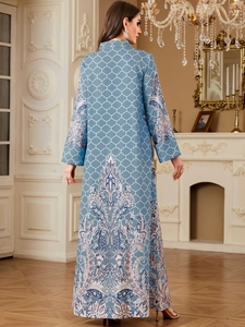 Detail of light blue paisley print dress showing the intricate pattern and flowing fabric