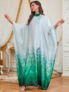 Detail of blue and green gradient kaftan dress with long sleeves and geometric texture