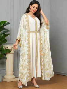 Close-up of gold floral embroidery and sequins on the white two-piece cardigan set